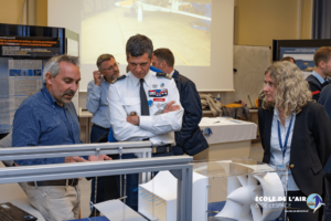 Un officier suivant les explications de deux personnes de l'Association Aéronautique et Astronautique de France (3AF)